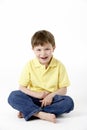 Young Boy Sitting In Studio Royalty Free Stock Photo