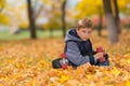 Young boy with skateboard alone in autumn park. Royalty Free Stock Photo