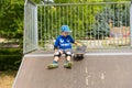 Young Boy with Skateboard Sitting on Ramp Royalty Free Stock Photo