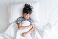 Young boy sleep on a white bed Royalty Free Stock Photo