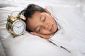 Young boy sleeping with alarm clock Royalty Free Stock Photo