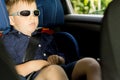 Young boy sleeping in the child car-seat Royalty Free Stock Photo