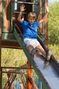 Young boy on a slide in the park