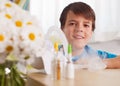 Young boy smiling from behind a nebulizer inhaler device