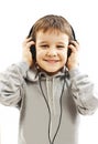 The young boy is smiling and listening to music Royalty Free Stock Photo