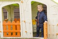 Young boy smiling in plastic house window at playground Royalty Free Stock Photo