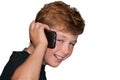 Young boy smiling while talking on a cell phone Royalty Free Stock Photo