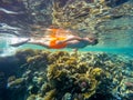 Young boy Snorkel swim in shallow water with coral fish