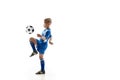 Young boy with soccer ball doing flying kick Royalty Free Stock Photo