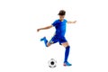 Young boy with soccer ball doing flying kick