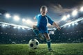 Young boy with soccer ball doing flying kick at stadium Royalty Free Stock Photo