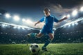 Young boy with soccer ball doing flying kick at stadium Royalty Free Stock Photo