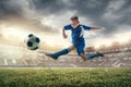 Young boy with soccer ball doing flying kick at stadium Royalty Free Stock Photo