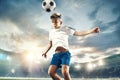 Young boy with soccer ball doing flying kick at stadium Royalty Free Stock Photo