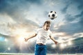 Young boy with soccer ball doing flying kick at stadium Royalty Free Stock Photo