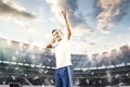 Young boy with soccer ball doing flying kick at stadium Royalty Free Stock Photo