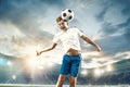 Young boy with soccer ball doing flying kick at stadium Royalty Free Stock Photo