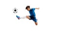 Young boy with soccer ball doing flying kick Royalty Free Stock Photo