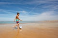 Young boy with soccer ball play on sea beach Royalty Free Stock Photo