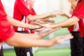 Young boy soccer players tap hands together for football training. Soccer players and goalkeeper traning speed hand together