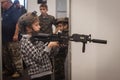 Young boy with softair rifle at Militalia 2013 in Milan, Italy Royalty Free Stock Photo