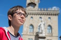 Young boy spectacled looking up outdoor over San Marino city-state. Vision, eyesight, sight, diopters, spectacles, glasses Royalty Free Stock Photo