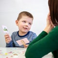 Young boy in speech therapy office. Preschooler exercising correct pronunciation with speech therapist. Child Occupational Therapy Royalty Free Stock Photo