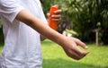 Young boy spraying insect repellents on skin in the garden Royalty Free Stock Photo