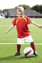 Young boy standing on a football field Royalty Free Stock Photo