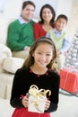 Young Boy Standing Holding Christmas Present