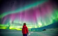 Young boy standing looking at spectacular northern lights aurora borealis. Royalty Free Stock Photo