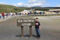 Young Boy at Yellowstone National Park beside an Old Faithful Geyser Sign