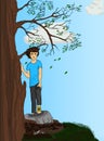 A young boy stands in a tree at the top of the hill Royalty Free Stock Photo