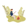 Young boy stay on chair and cook marshmallow on campfire