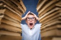 Young boy in stress getting crazy while studying and doing homework in children education concept sitting between two Royalty Free Stock Photo