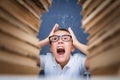 Young boy in stress getting crazy while studying and doing homework in children education concept sitting between two Royalty Free Stock Photo