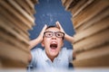 Young boy in stress getting crazy while studying and doing homew Royalty Free Stock Photo