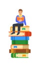 Young boy student sits on stack of giant books