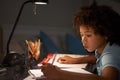 Young Boy Studying At Desk In Bedroom In Evening Royalty Free Stock Photo