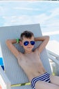 Young boy in a swimsuit on a shelf by the pool Royalty Free Stock Photo