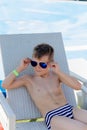 Young boy in a swimsuit on a shelf by the pool Royalty Free Stock Photo