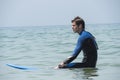 Young boy surfing in the sea, waiting waves Royalty Free Stock Photo