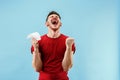 Young boy with a surprised expression bet slip on blue background Royalty Free Stock Photo