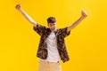 Young boy with surprised happy expression isolated over bright yellow studio background. Human facial emotions and Royalty Free Stock Photo