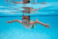 Young boy swim and dive underwater. Under water portrait in swim pool. Child boy diving into a swimming pool. Beach sea Royalty Free Stock Photo