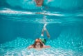 Young boy swim and dive underwater. Under water portrait in swim pool. Child boy diving into a swimming pool. Summer Royalty Free Stock Photo