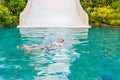 A young boy swimming and having fun in pool at waterpark