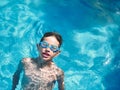Young boy swimming on a swimming pool. close up look, with copy space Royalty Free Stock Photo