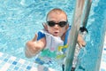 Young boy in a swimming pool giving a thumbs up Royalty Free Stock Photo