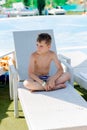 Young boy in a swimsuit on a shelf by the pool Royalty Free Stock Photo